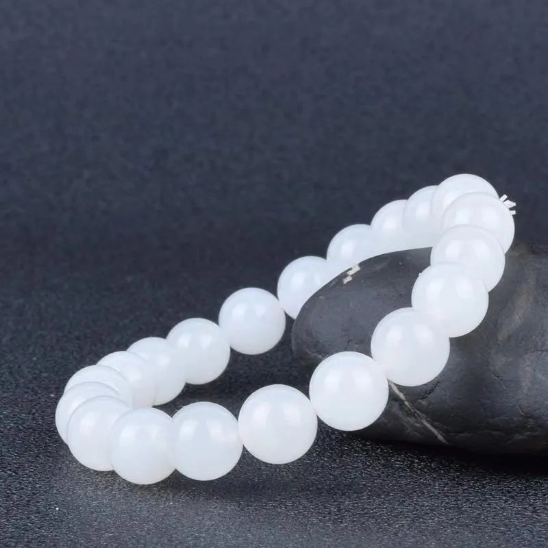 Hotan white jade goat fat round bead bracelet 10mm Hetian jade unisex national style on light background