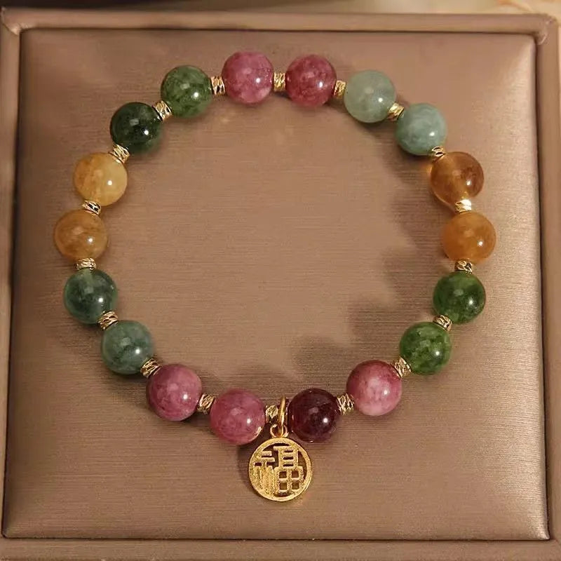 Natural colour tourmaline bracelet with electroplated finish showing geometric shape and delicate flower design