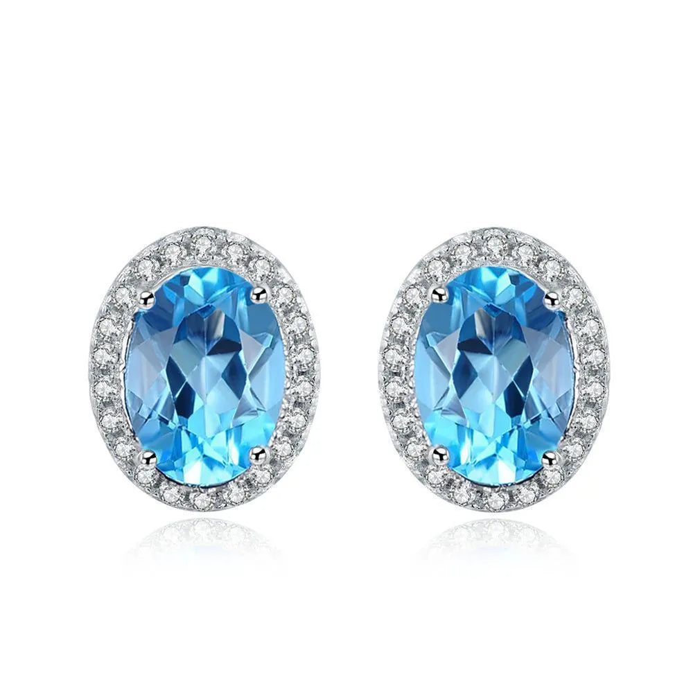 925 sterling silver jewellery set with blue topaz stones showing earrings, ring, pendant, and necklace with chain in geometric design
