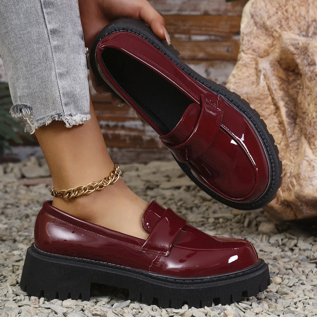 Plus size women's black chunky heel loafers with a slip-on mid-top design and rubber sole.