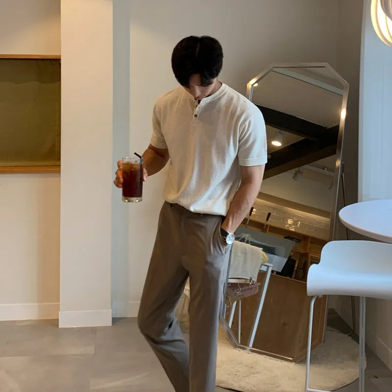 Man wearing a thin black slim-fit knitted short-sleeved pullover shirt.