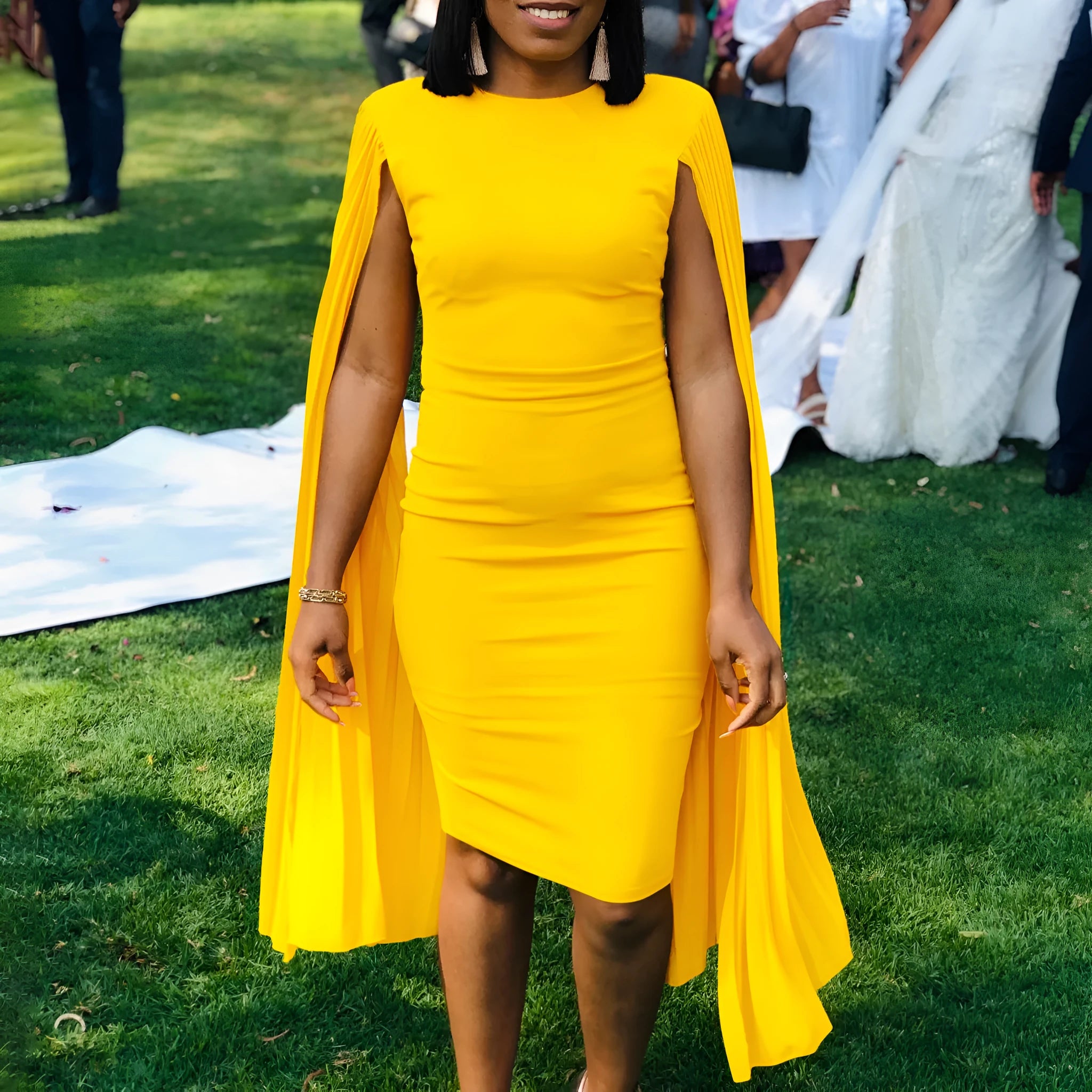 Yellow women's long sleeve evening gown with round neck, high waist, and a pleated shawl detail.
