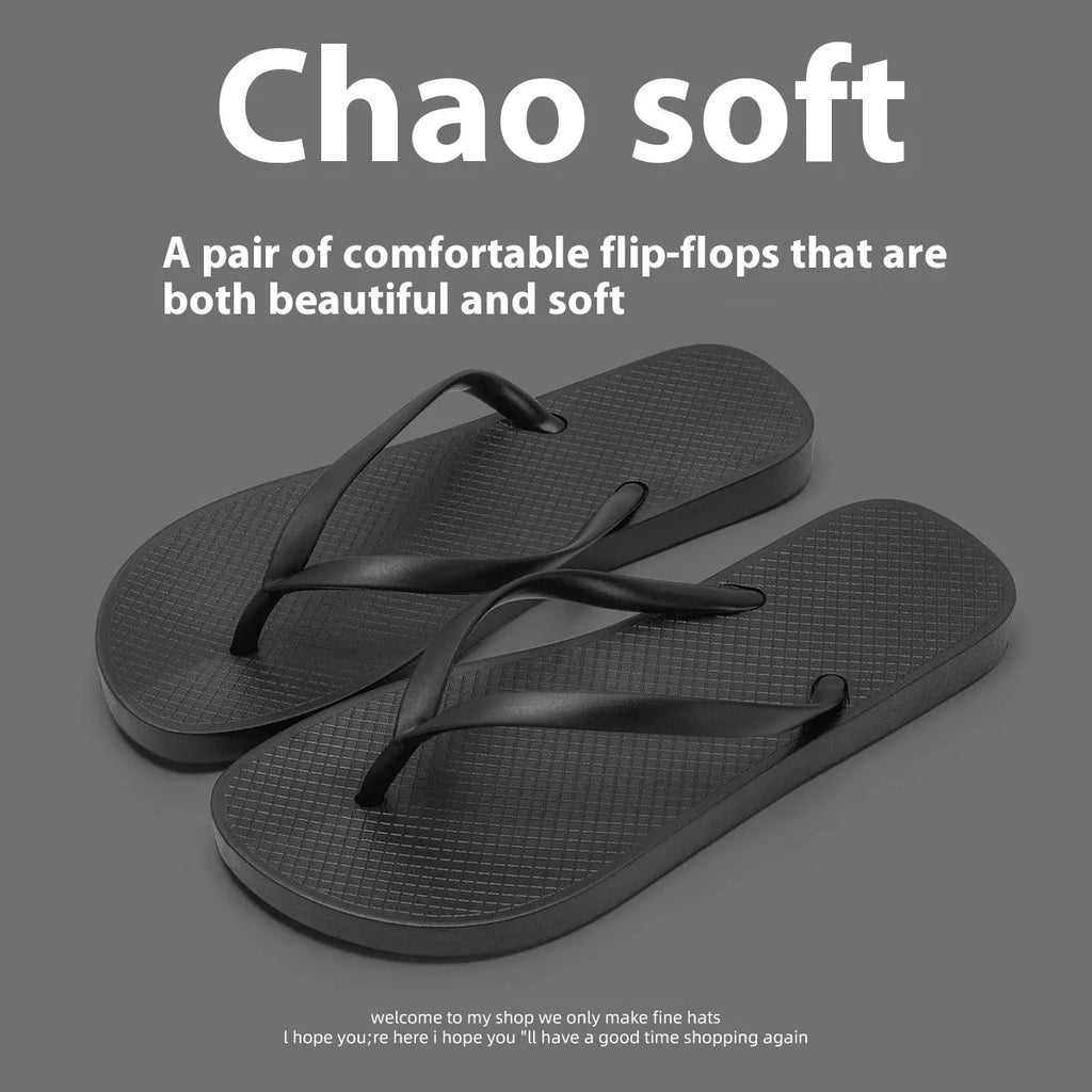 Orange foldable plastic beach slippers with a non-slip hollow-out PVC sole on a sandy background.