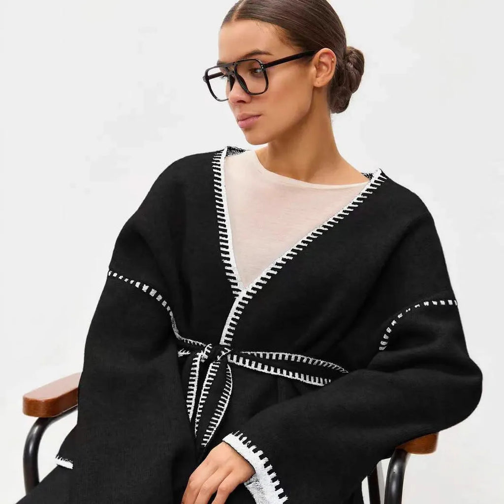 Loose lace-up front knitted cardigan in camel colour, showing mid-length fit and long sleeves.