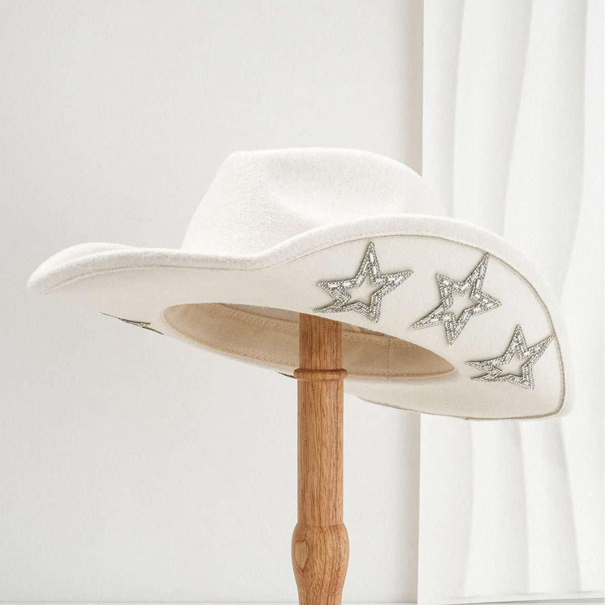 Brown polyester Western denim top hat with a conical crown and a silver hexagonal star decoration on the front.