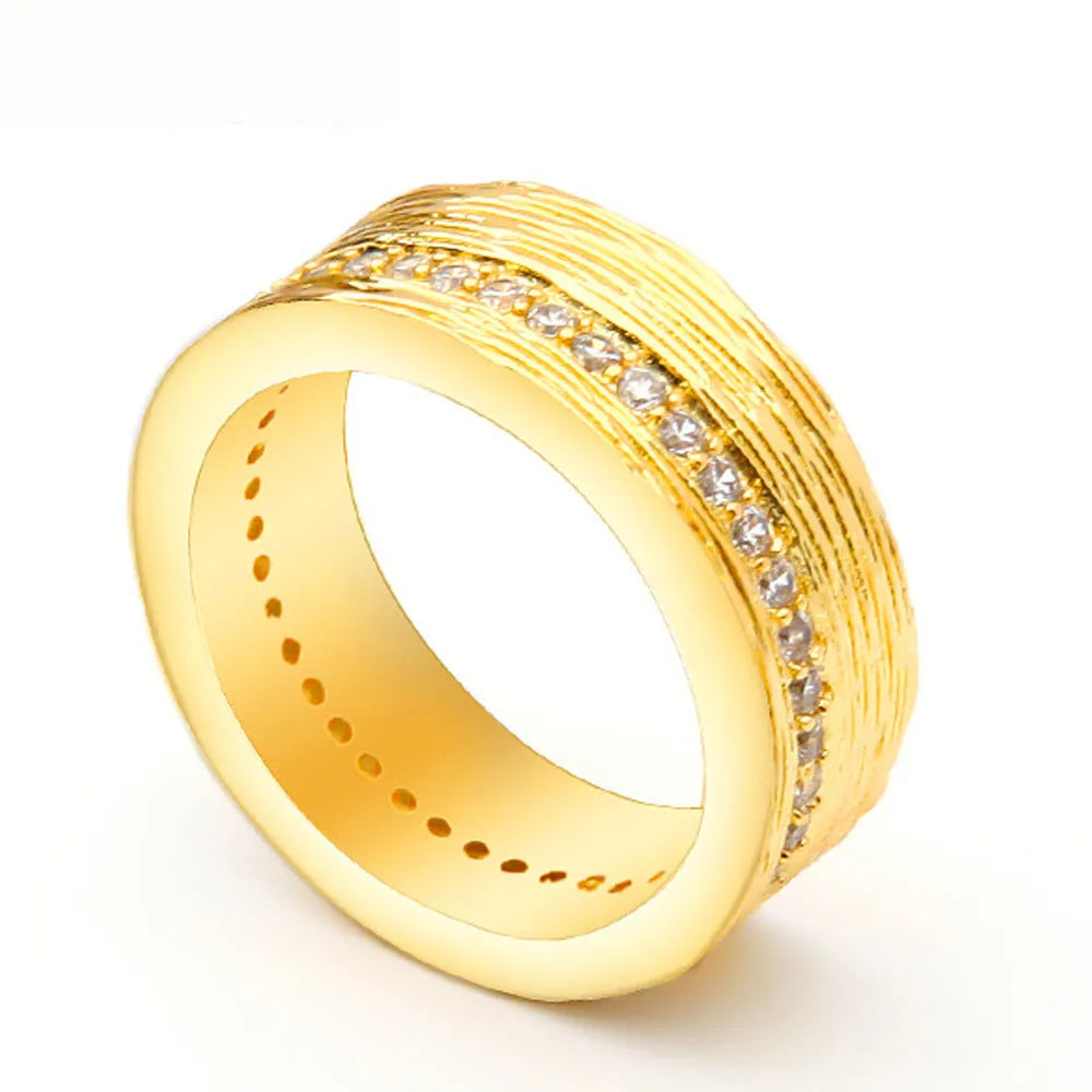 Gold geometric zircon ring in electroplated copper showing angular design details