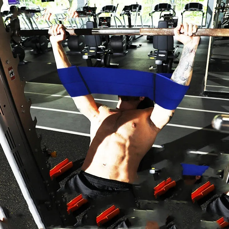 Elastic elbow support bandage in black, shown on an adult arm during exercise.