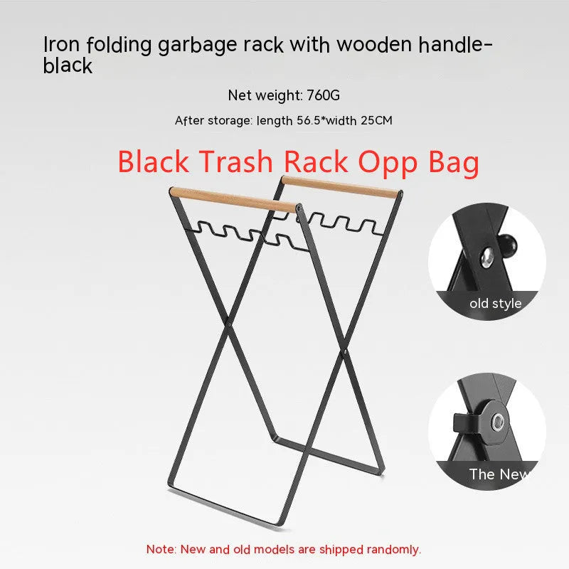 Black outdoor folding trash rack with wooden handle holding a white bin bag open.