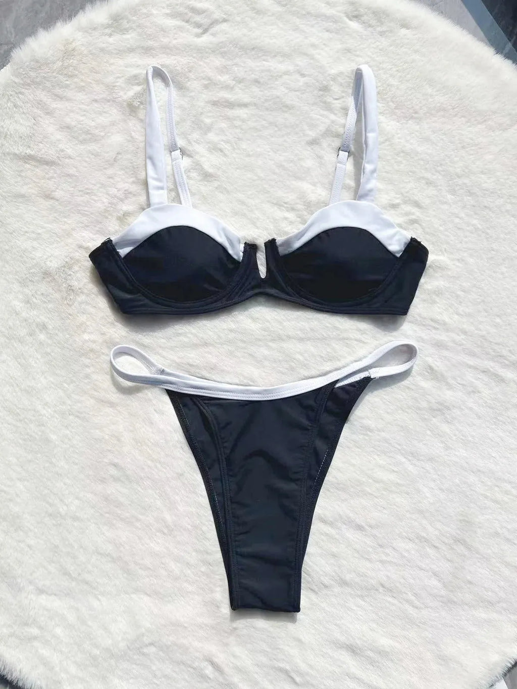 Women's low waist black bikini swimsuit with stitching split detail and briefs style.