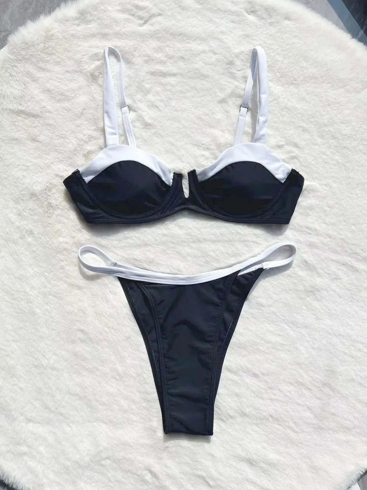 Women's low waist black bikini swimsuit with stitching split detail and briefs style.