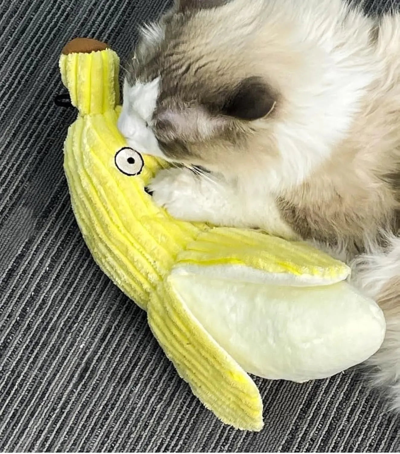 Yellow banana-shaped cat crinkle toy with plush fabric on a plain background.