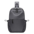 Grey men's waterproof chest bag shown on shoulder, displaying its 33cm height and spacious main compartment.