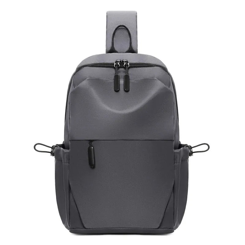 Grey men's waterproof chest bag shown on shoulder, displaying its 33cm height and spacious main compartment.