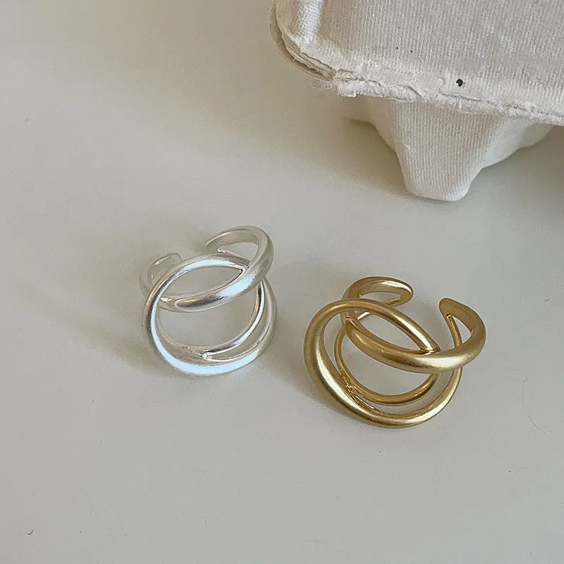 Three-dimensional interlaced geometric open ring in matte metal with gold electroplating