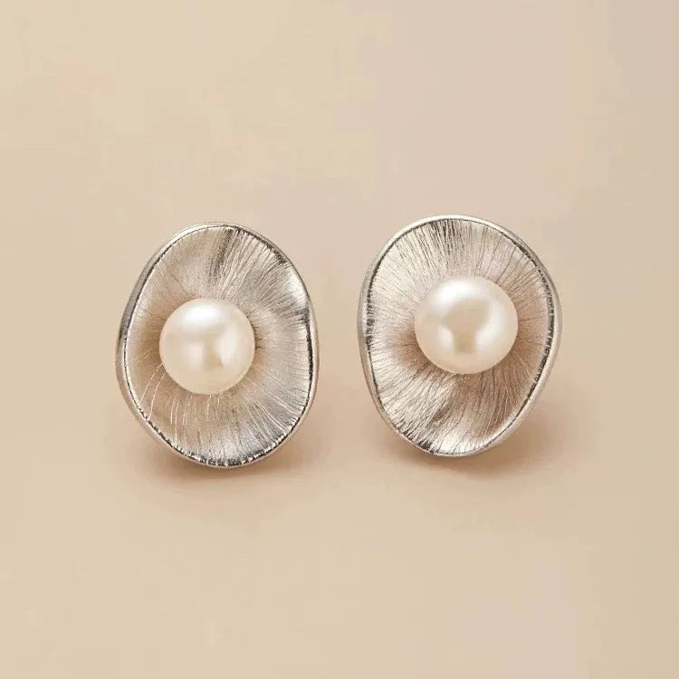 Gold electroplated sterling silver pearl ear studs with geometric design and surgical steel posts
