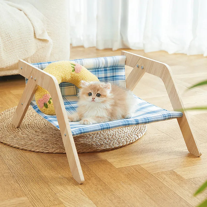 Wooden elevated cat bed with blue cloth hammock in beach chair design for indoor cats