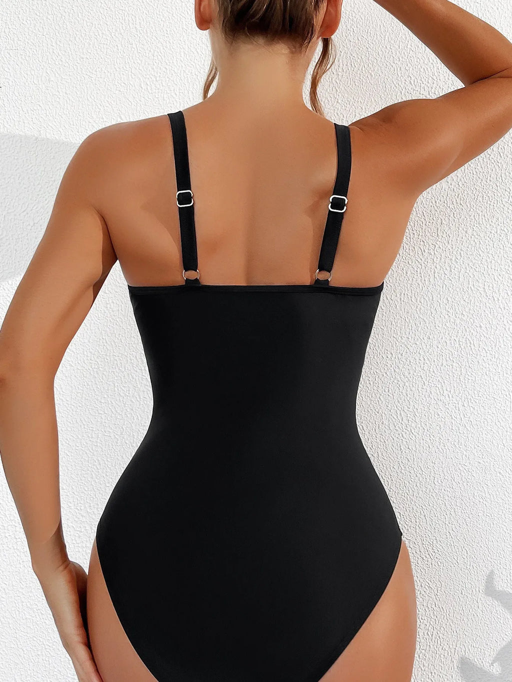Black halter neck one-piece swimsuit for women, briefs style, made from nylon fabric.