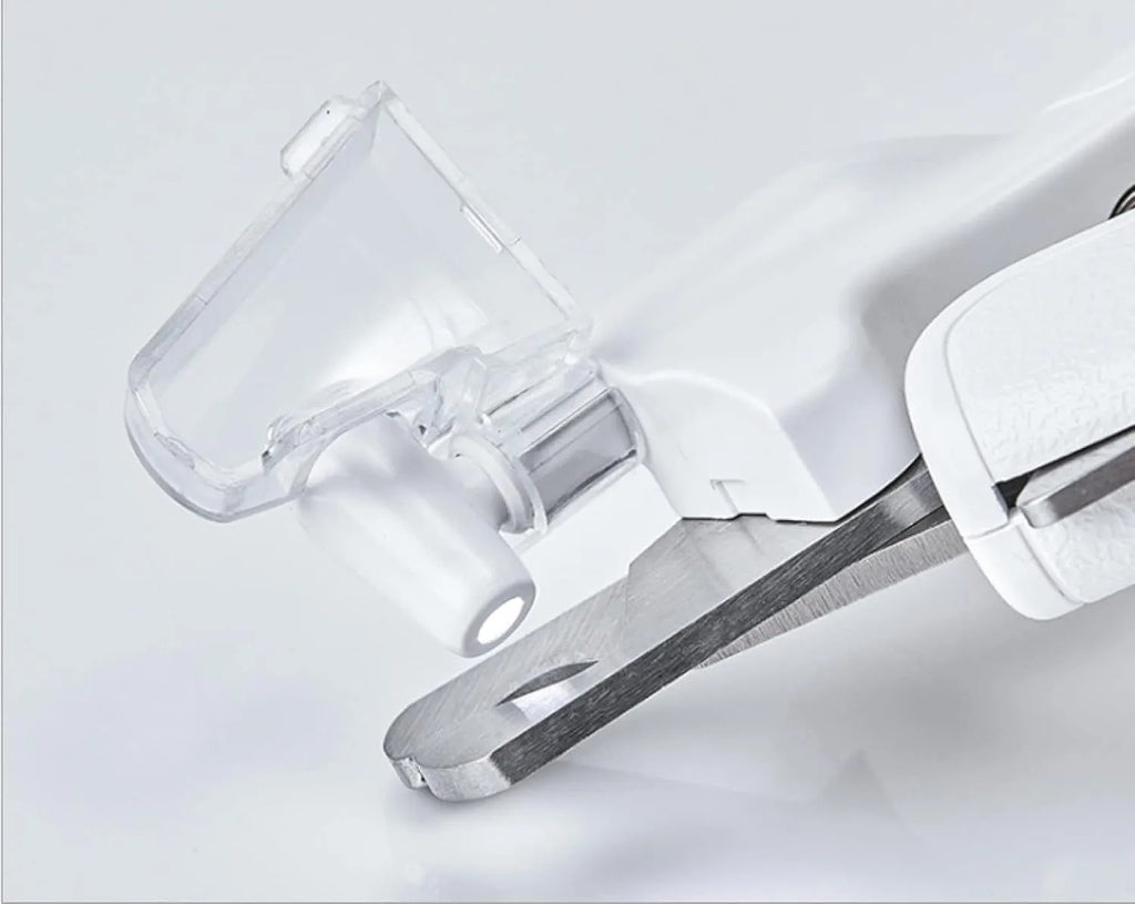 White pet nail clippers with built-in LED light and transparent anti-splash guard.