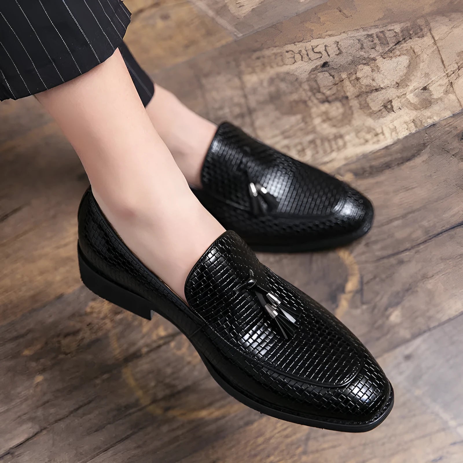 Men's black slip-on business shoes with pointed toe and tassel detail