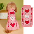 Small dog wearing an acrylic sweater with pink bow and love heart design