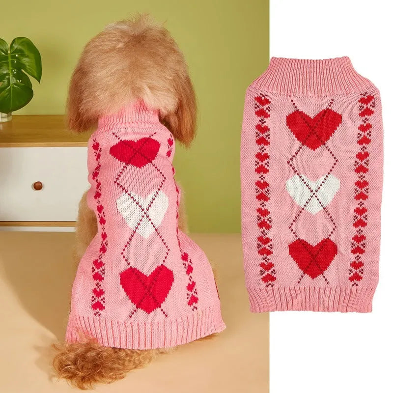 Small dog wearing an acrylic sweater with pink bow and love heart design