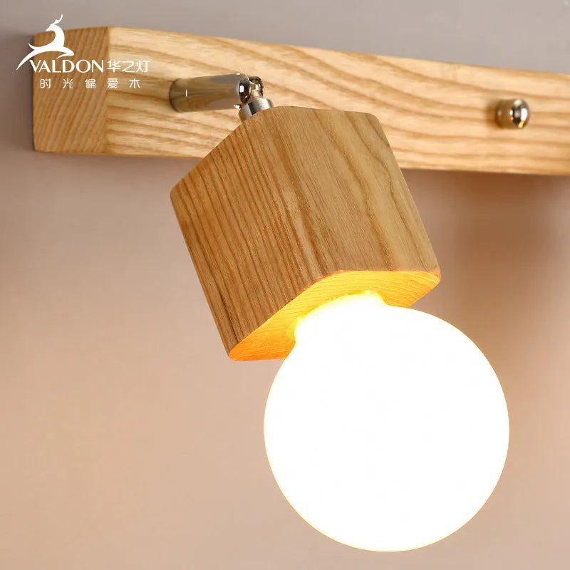 Single-head mirrored cabinet LED wall lamp with a 24cm size on a white wall.