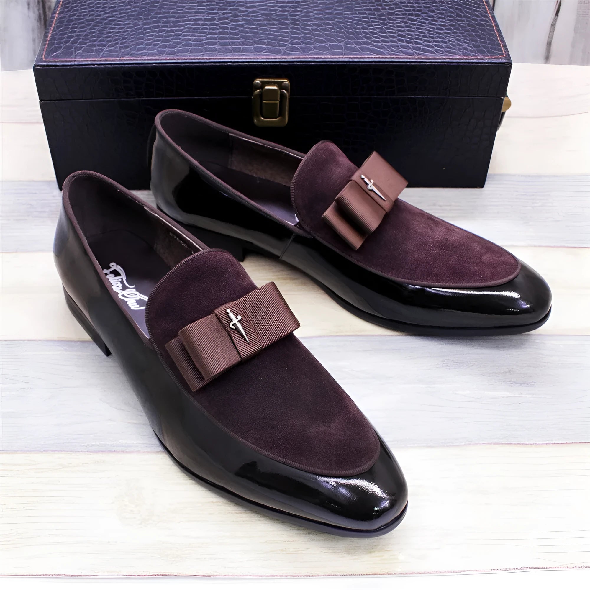 Men's glossy patent leather low-top shoes with a tassel in black, shown from a side view.