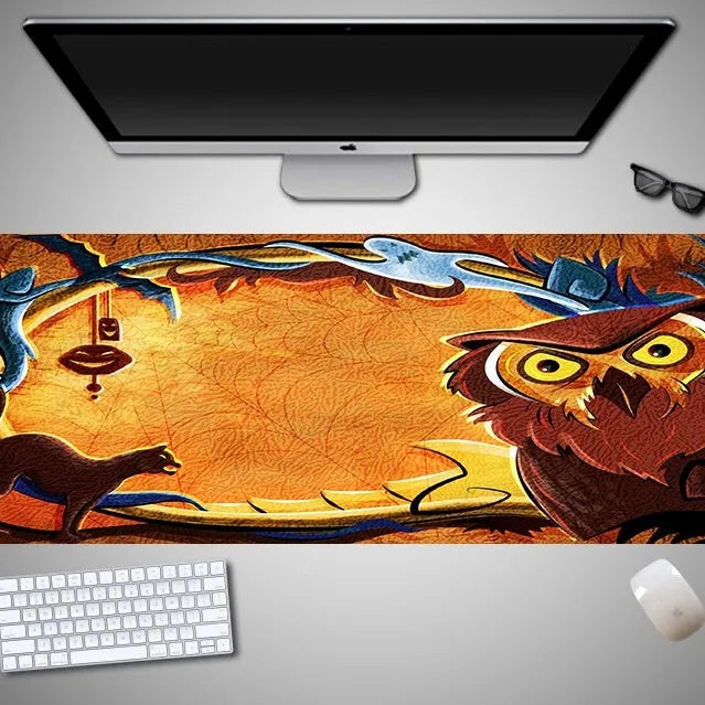 Oversized Halloween-themed rubber cloth mouse pad on a desk, showing non-slip base and large surface area.