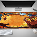 Oversized Halloween-themed rubber cloth mouse pad on a desk, showing non-slip base and large surface area.