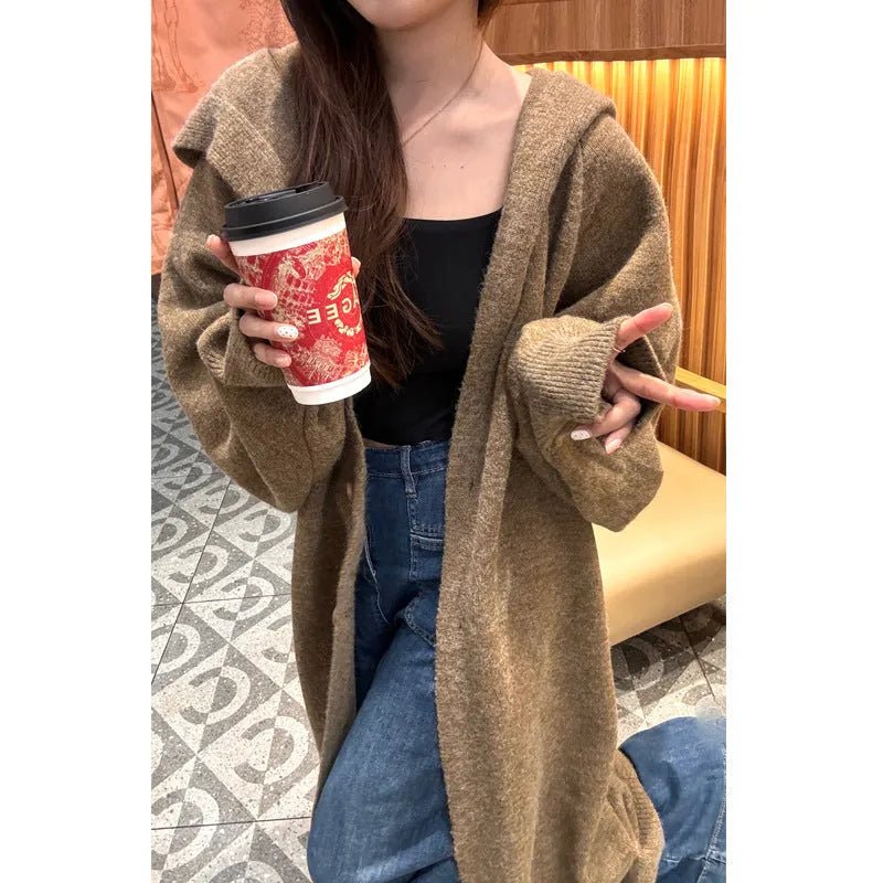 Women's long hooded knitted cardigan in loose fit, shown in oatmeal colour.