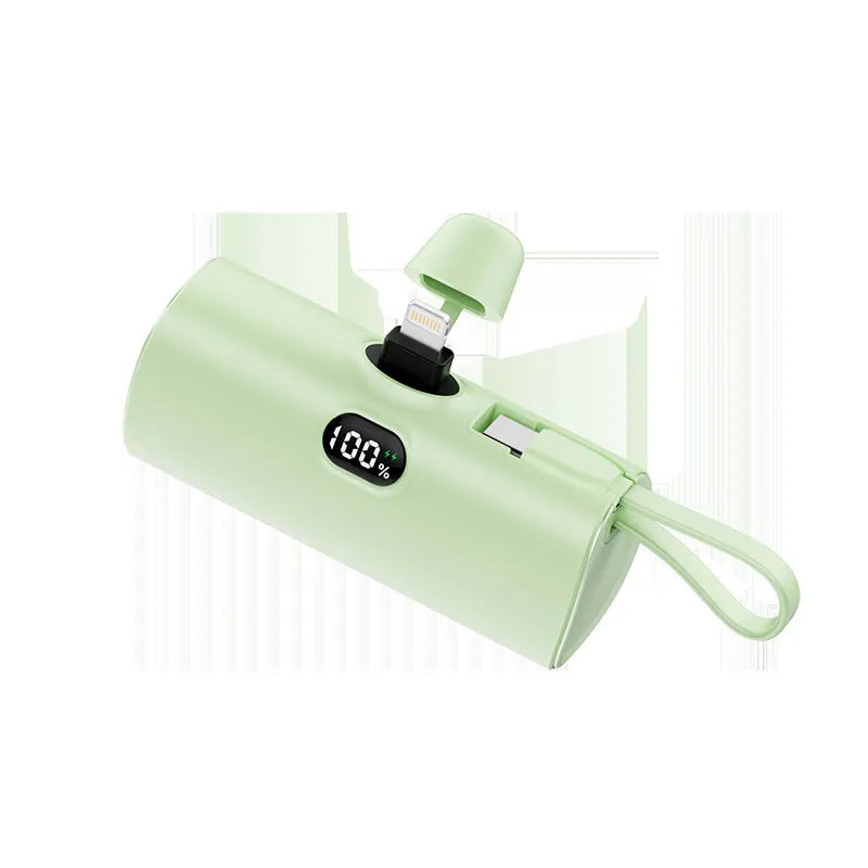 Compact wireless power bank with digital display showing battery percentage and built-in folding plug