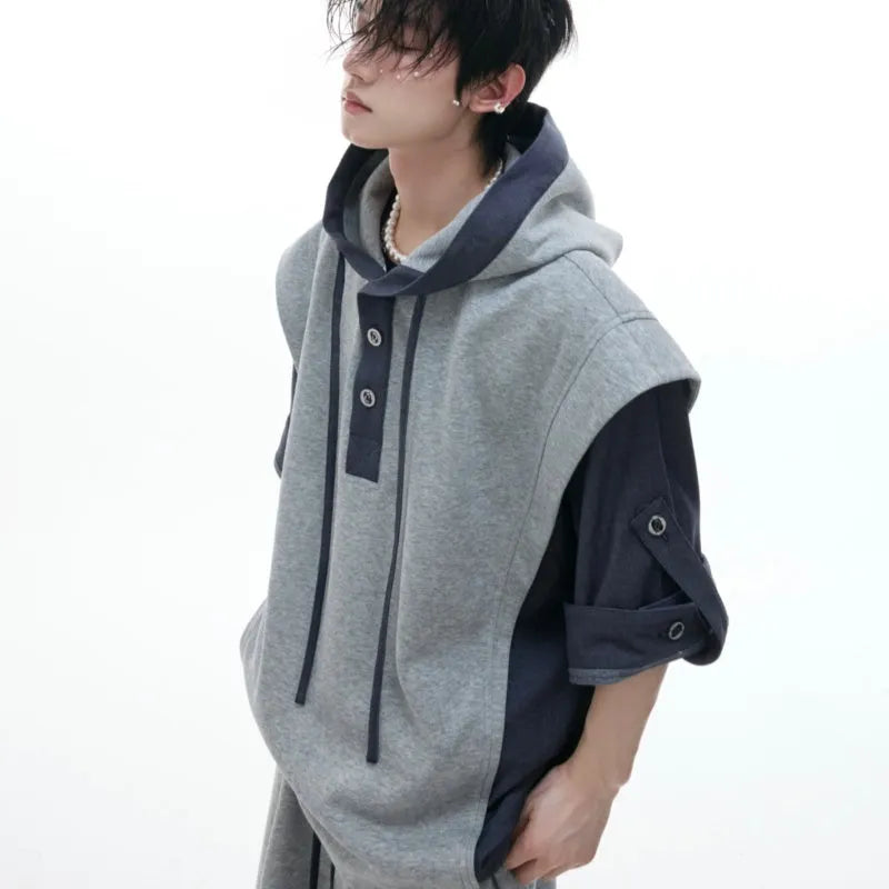 Men's black hooded short sleeve polyester sports suit with textured stitching and matching trousers on a grey background.