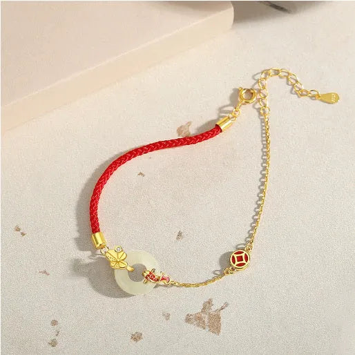 Gold electroplated 925 sterling silver bracelet with red rope and peace buckle featuring koi fish design