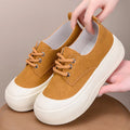 Women's beige suede platform loafers with round toe and front lace-up, on a white background.