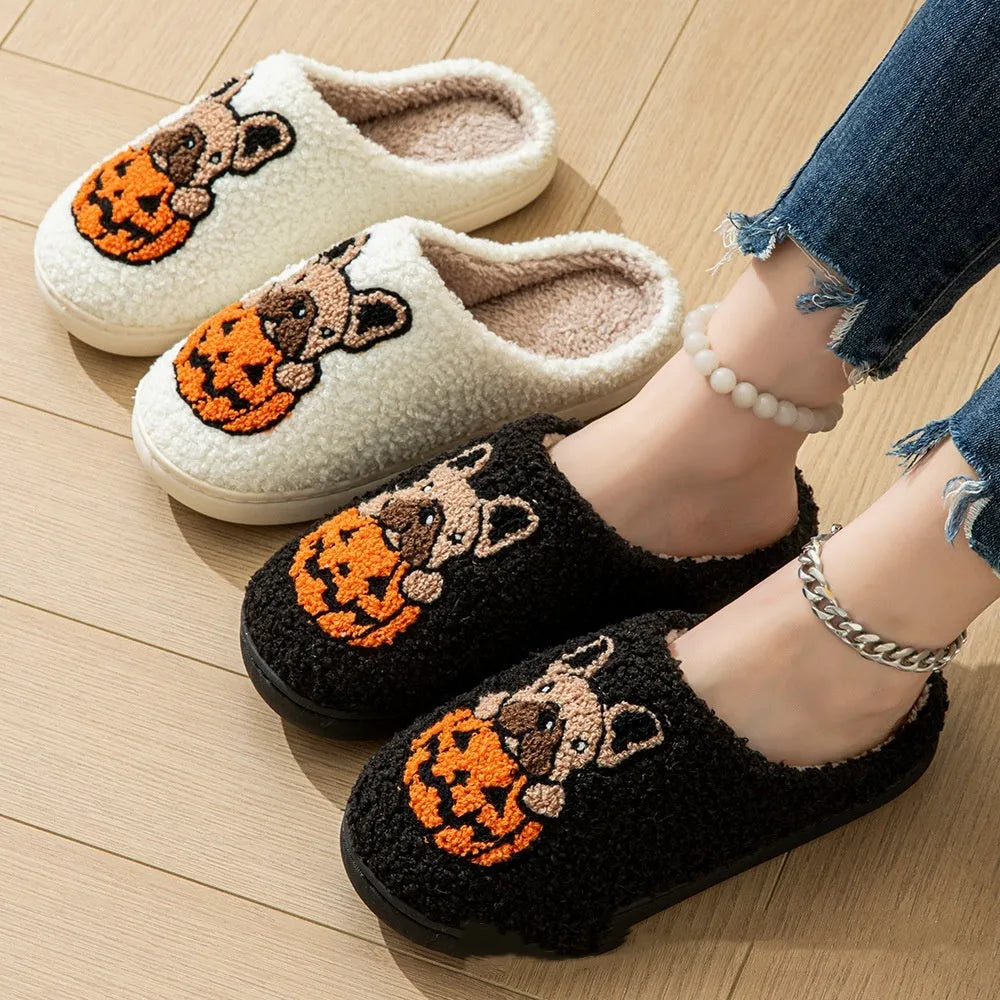 Black and white Halloween slippers with pumpkin design featuring plush uppers and non-slip rubber soles.