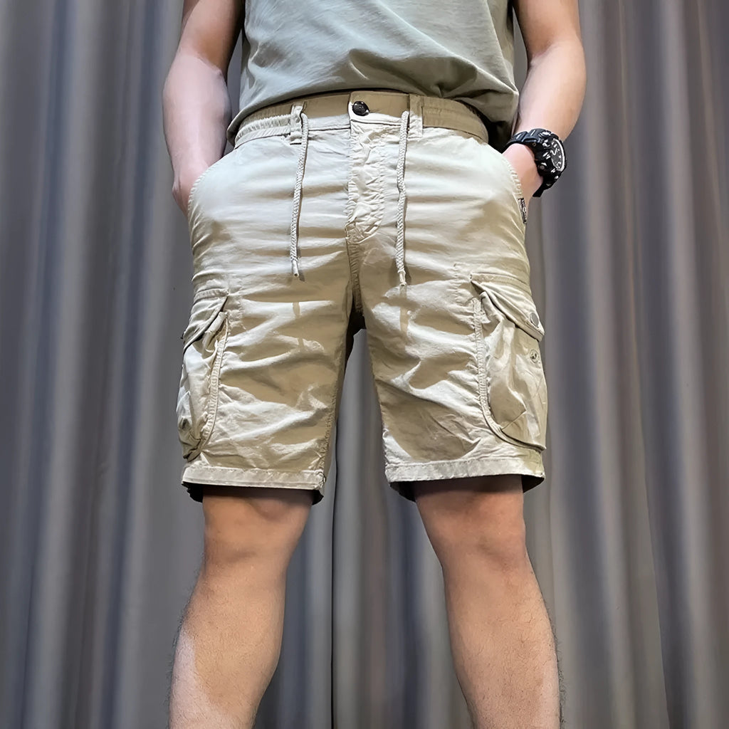 Loose straight-leg overalls pants in khaki with multiple cargo pockets on the legs.