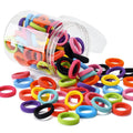 Multicoloured assortment of 100 soft cotton baby hair ties in a small jar, showing seamless design.