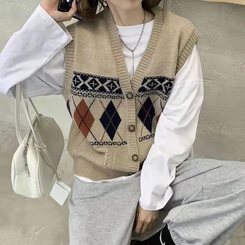 Woman wearing a khaki sleeveless cardigan with a diamond plaid pattern, loose fit.