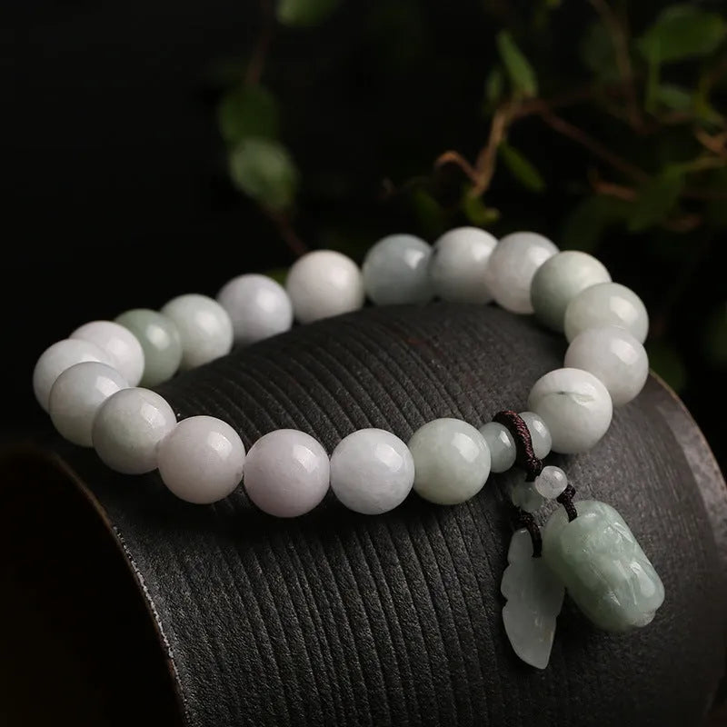 Jade hanging bracelet with Maitreya Buddha, apple, gourd, and money bag charms