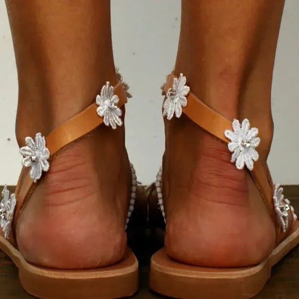 Brown women's Roman sandals with flower pattern and herringbone toe design