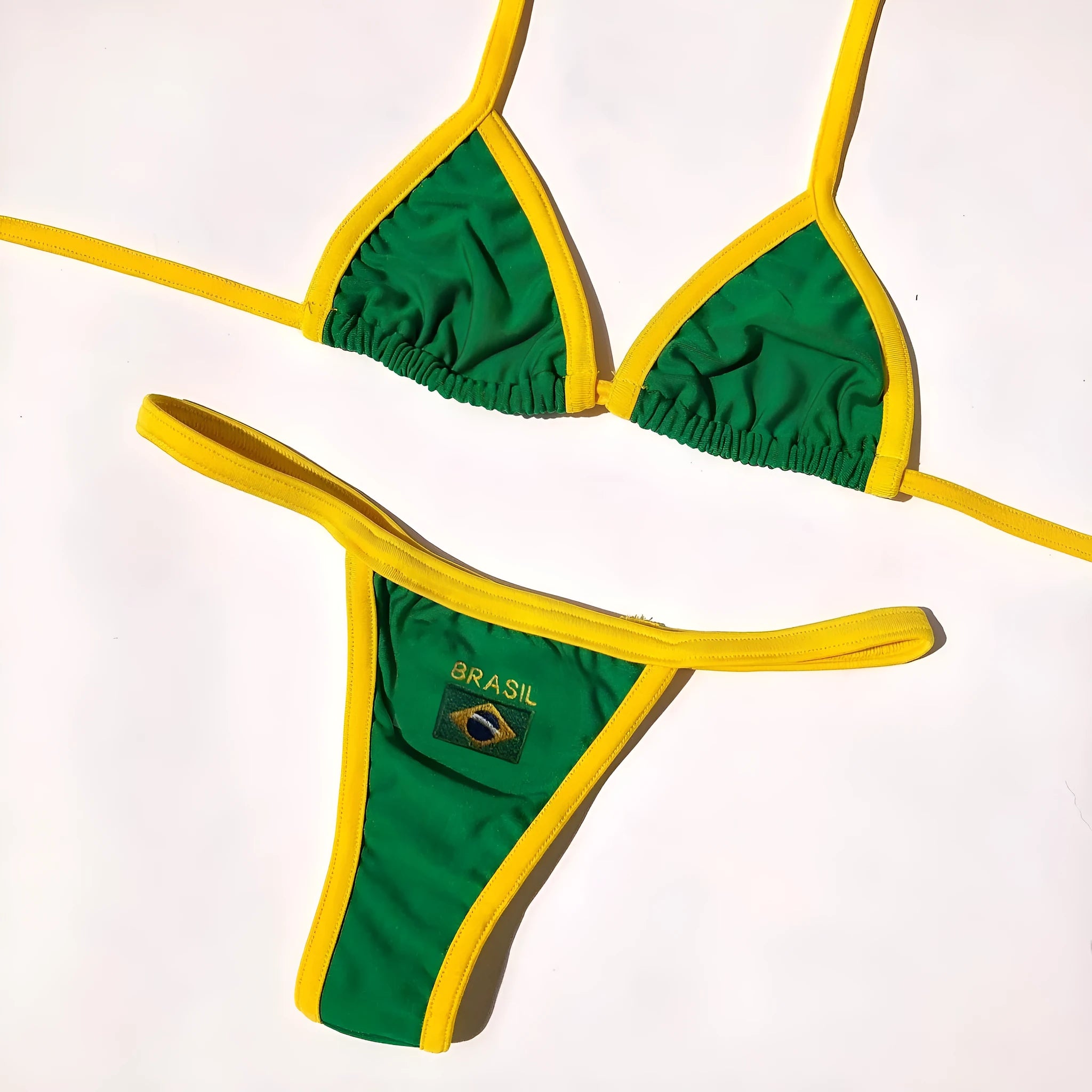 Yellow women's bikini set with T-back bra and shorts-length pants on a mannequin.