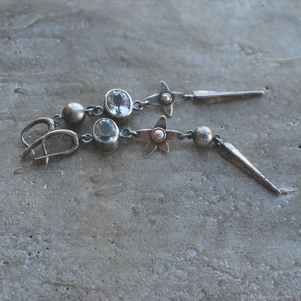 Geometric long pendant earrings with rhinestone drops in antique silver finish.