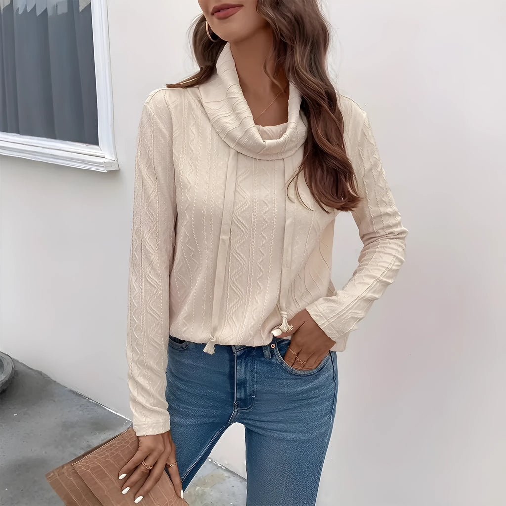 Apricot coloured women's hooded pullover sweater with long sleeves on a hanger.