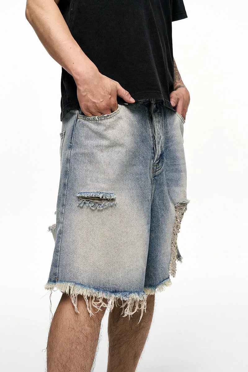 Men's light blue baggy denim shorts with a mid-rise waist and wide leg fit.