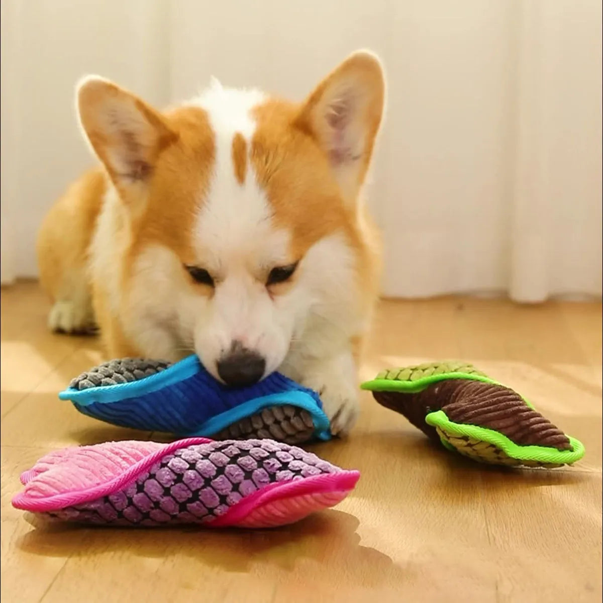 Blue teddy dog toy with squeaker bone, showing soft corn fleece lining and bite-resistant construction