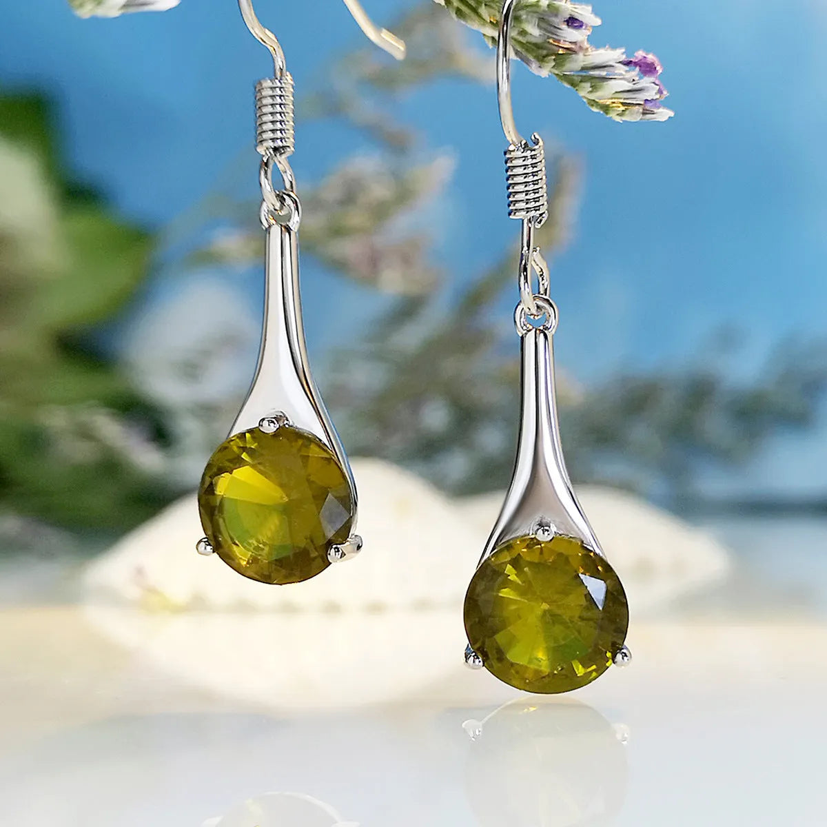A pair of olive green retro-style drop earrings made from alloy on a white background.