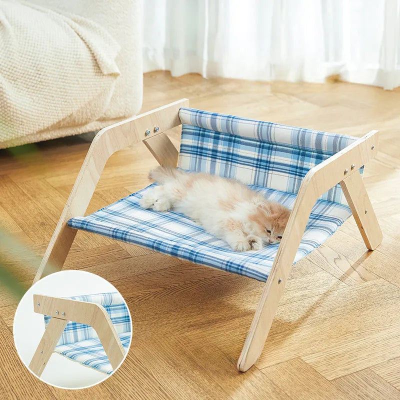 Wooden elevated cat bed with blue cloth hammock in beach chair design for indoor cats