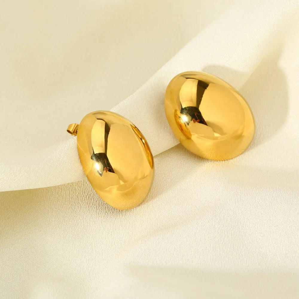 A pair of geometric line design ear studs with a high-shine glazed silver finish.