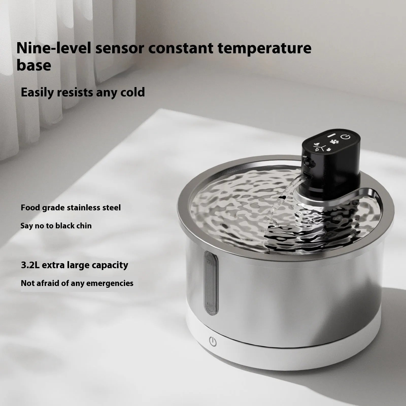 Stainless steel heated pet water fountain with white control base on a wooden floor.