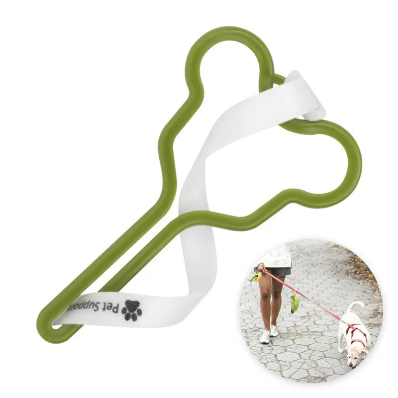 A hands-free dog poop bag holder with a fixed clip and adjustable black Velcro strap, shown attached to a dog lead.